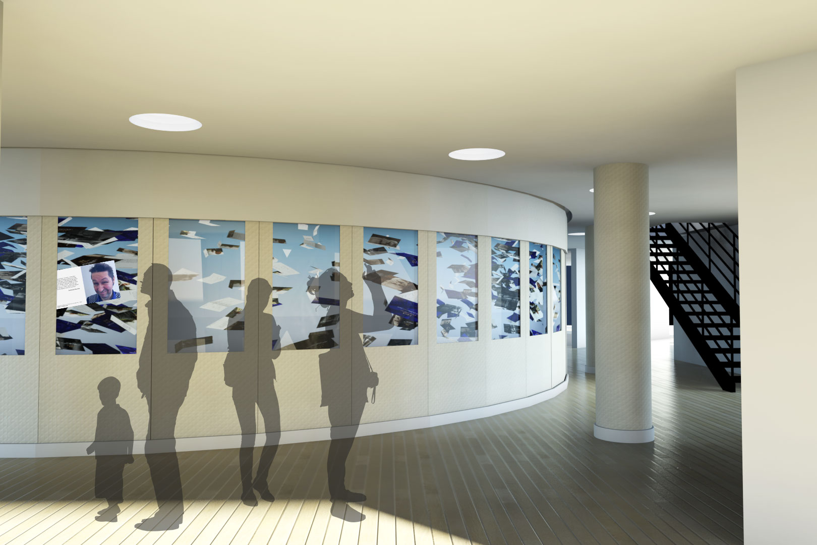 L'image montre un intérieur moderne avec un espace circulaire. Sur un mur, il y a une exposition de photos ou d'œuvres artistiques présentées dans des cadres. Au premier plan, on aperçoit des silhouettes de personnes, dont un enfant. L'éclairage est doux, et le sol est en bois, créant une ambiance chaleureuse. À l'arrière-plan, on distingue un escalier moderne qui mène à un autre niveau. L'ensemble de la scène semble contemporain et accueillant.