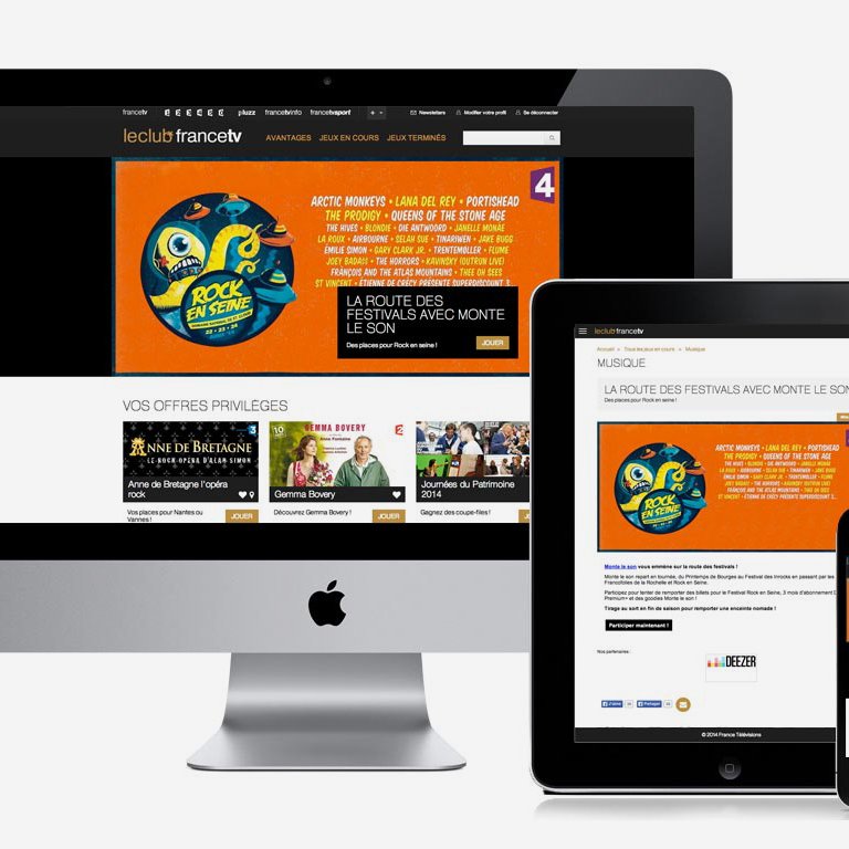L'image montre une interface de site web affichée sur plusieurs appareils : un ordinateur de bureau, une tablette et un smartphone. Le site semble promouvoir des festivals de musique, avec un accent sur un événement particulier, affichant un design coloré et attirant. On peut apercevoir du texte et des images qui mettent en avant divers contenus liés à la musique.